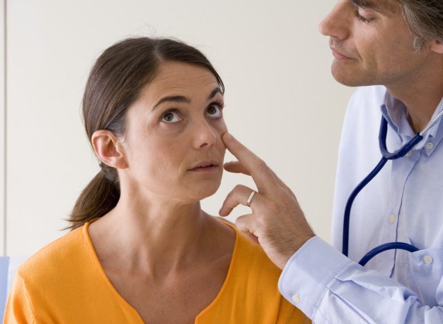 Doctor checking patient for anemia symptoms