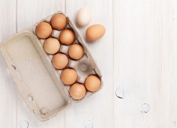 eggs in carton on wood table