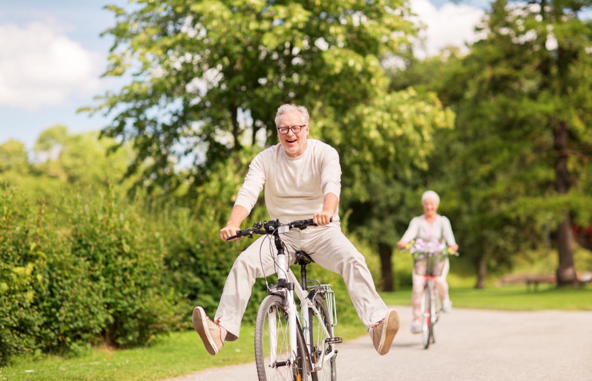 happy senior couple riding bicycles