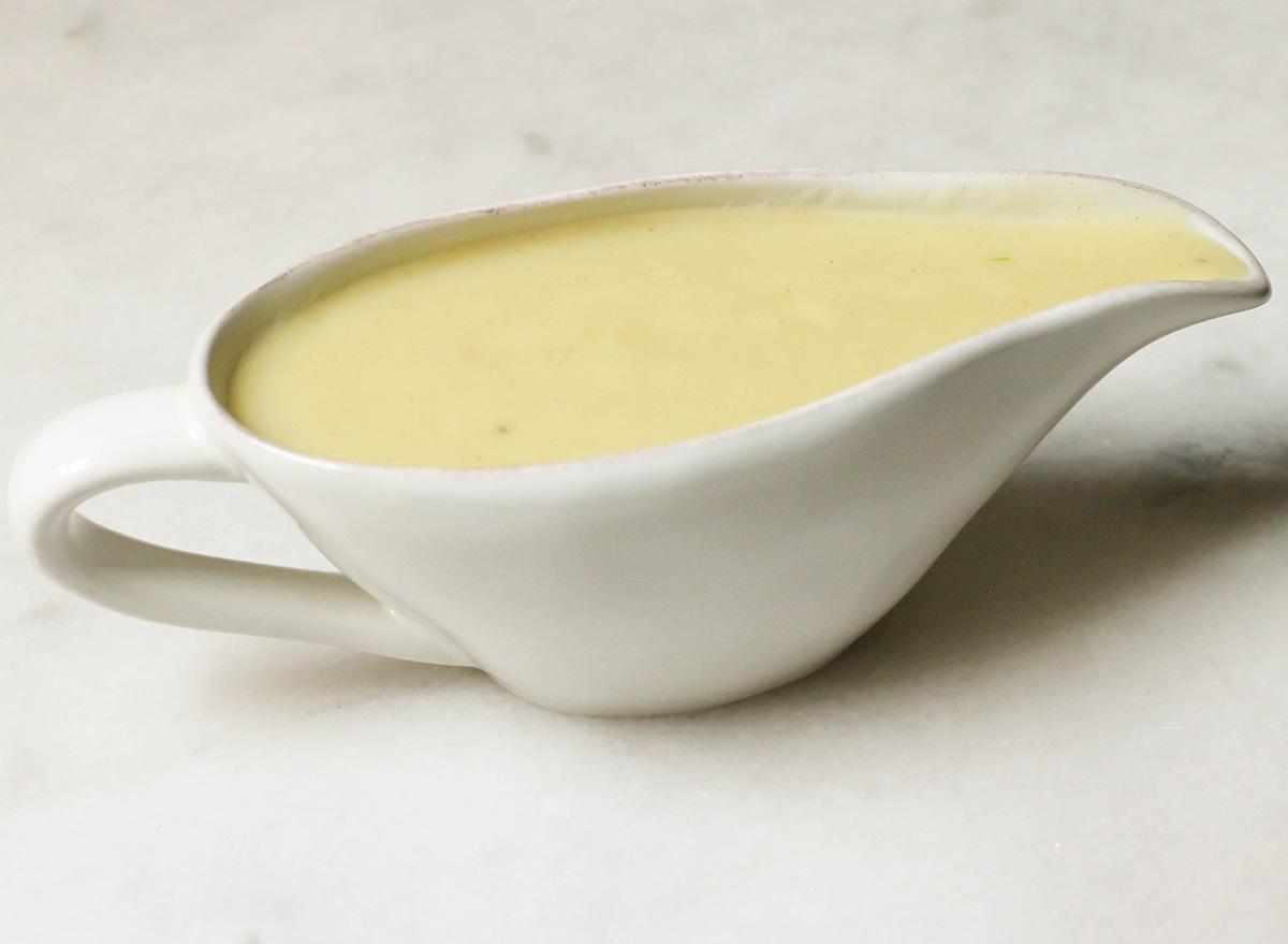 Homemade gravy recipe in a gravy boat on a marble counter
