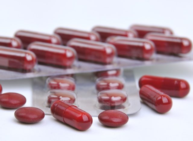 assortment of red pills and capsules of iron supplements