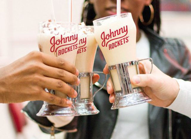 people doing cheers with johnny rockets milkshakes