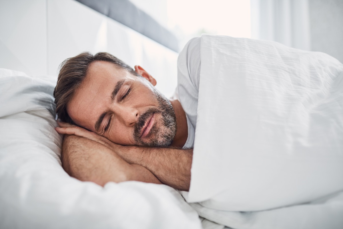 man sleeping in bed