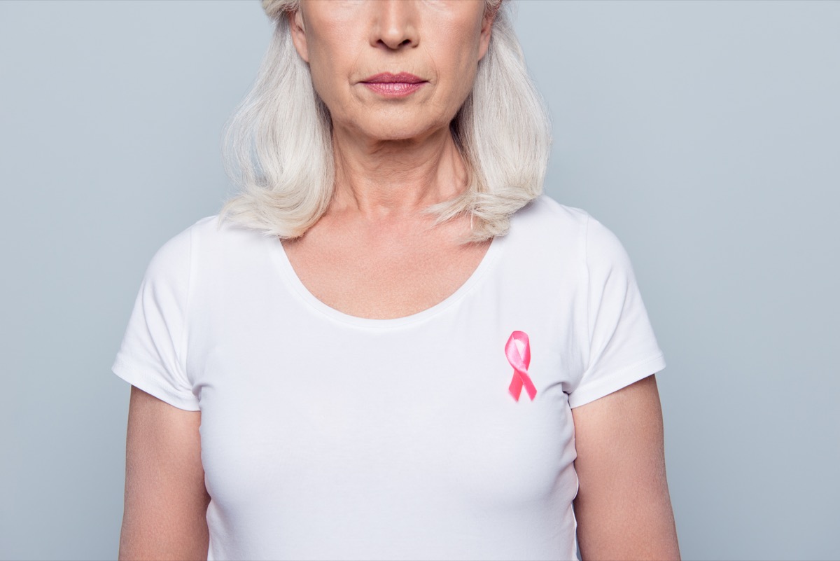 woman in white t-shirt with breast cancer pink ribbon