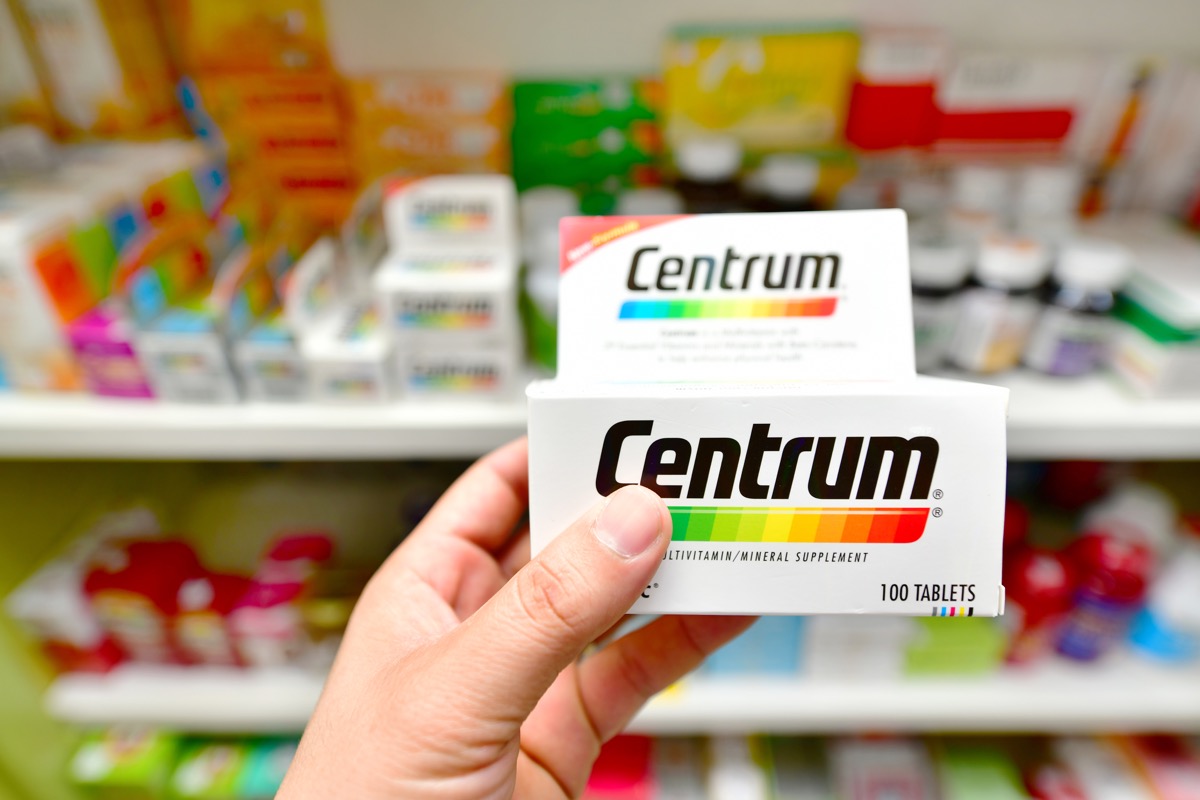 Pharmacist holding Centrum box multivitamin