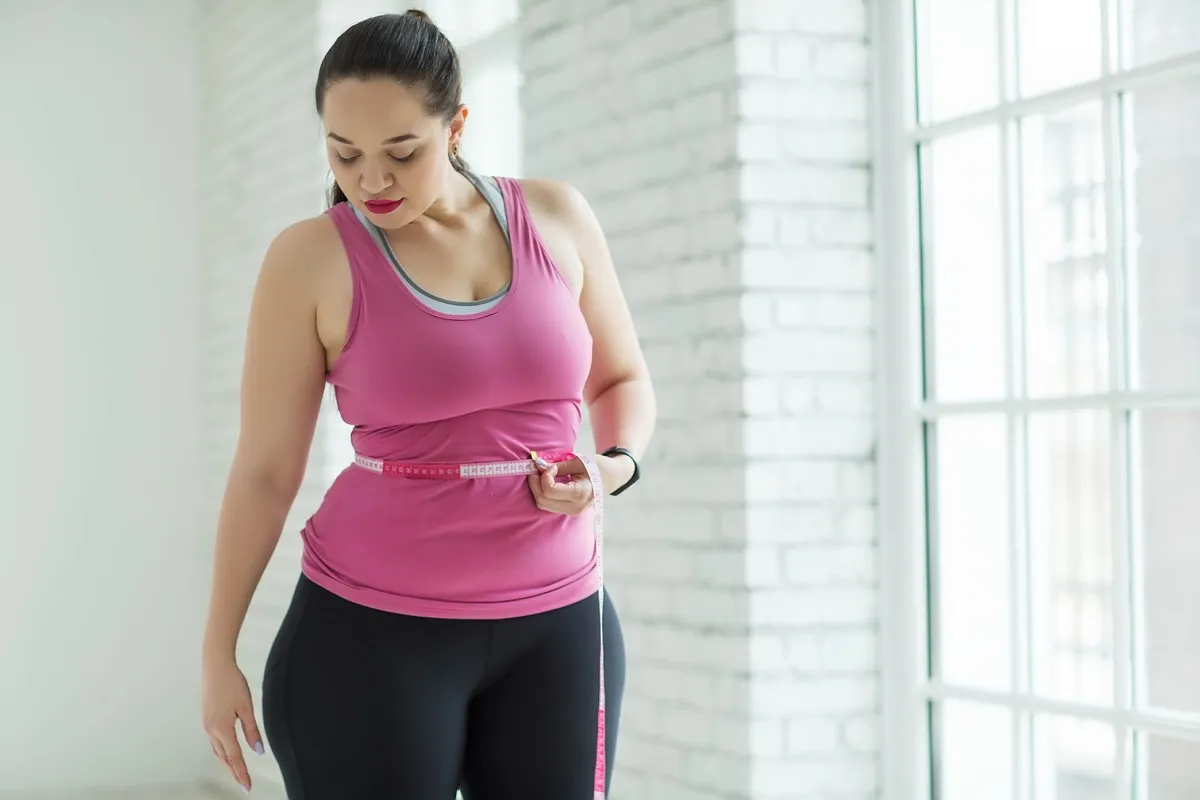 Transformation. Young fat woman becoming slim fit girl. Stock Photo