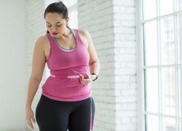 Overweight woman checking the scale