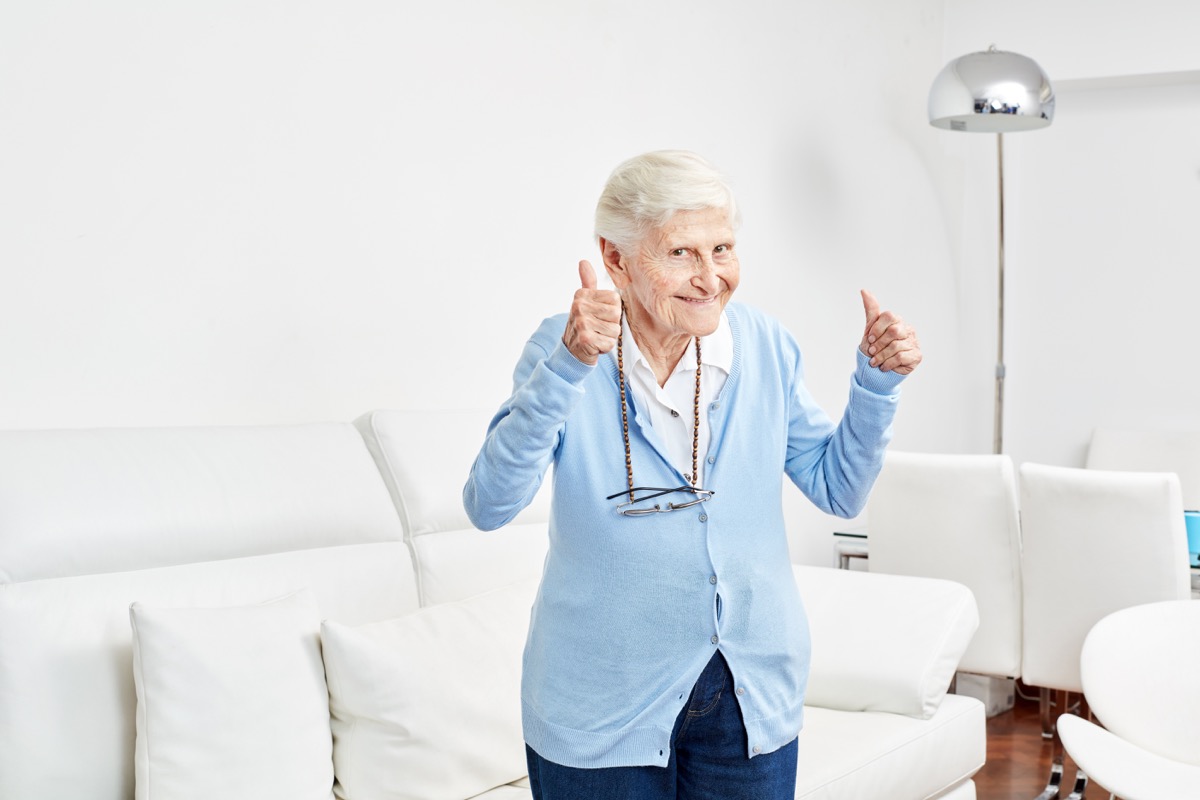 Optimistic old woman holds the thumbs up full of joy and vitality