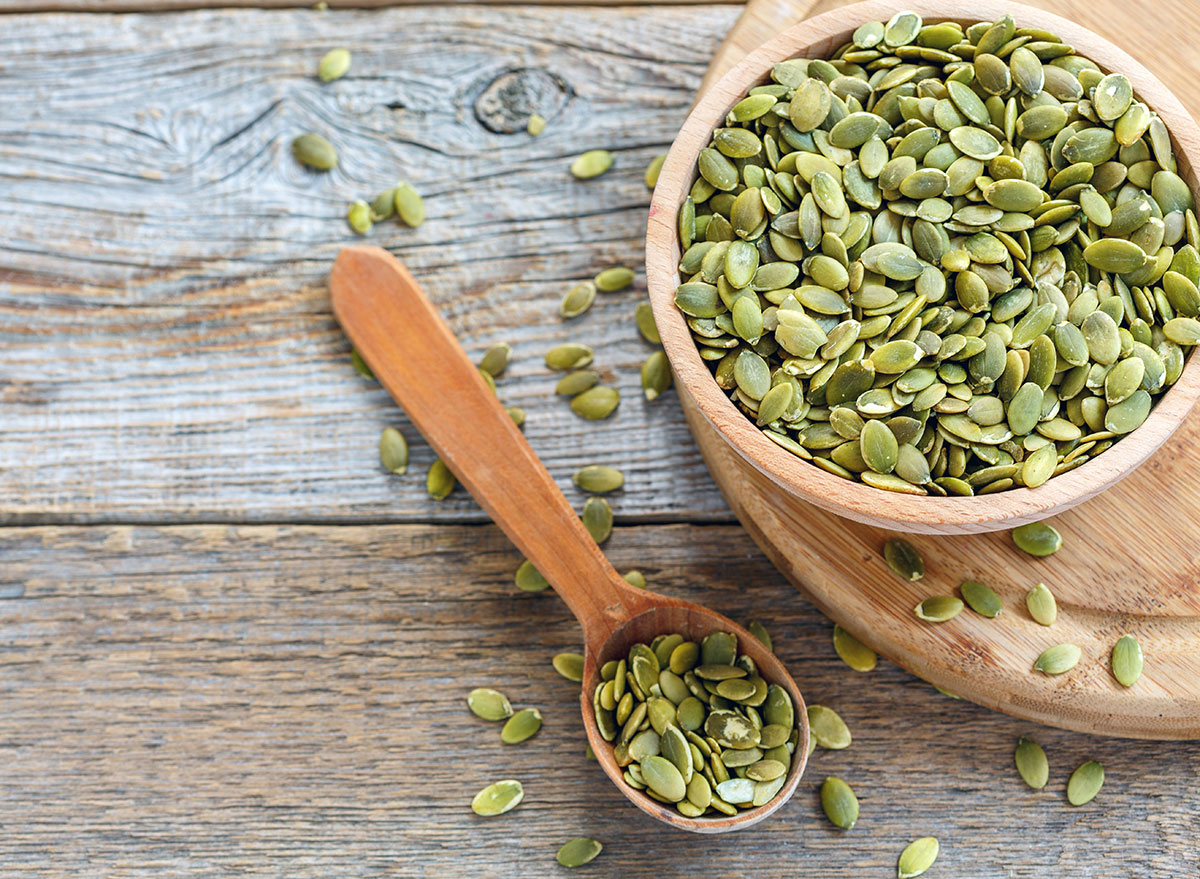 pumpkin seeds in bowl with spoon