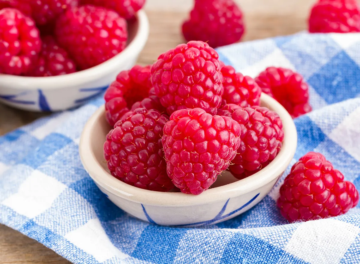 rasberries in bowl on checkered cloth