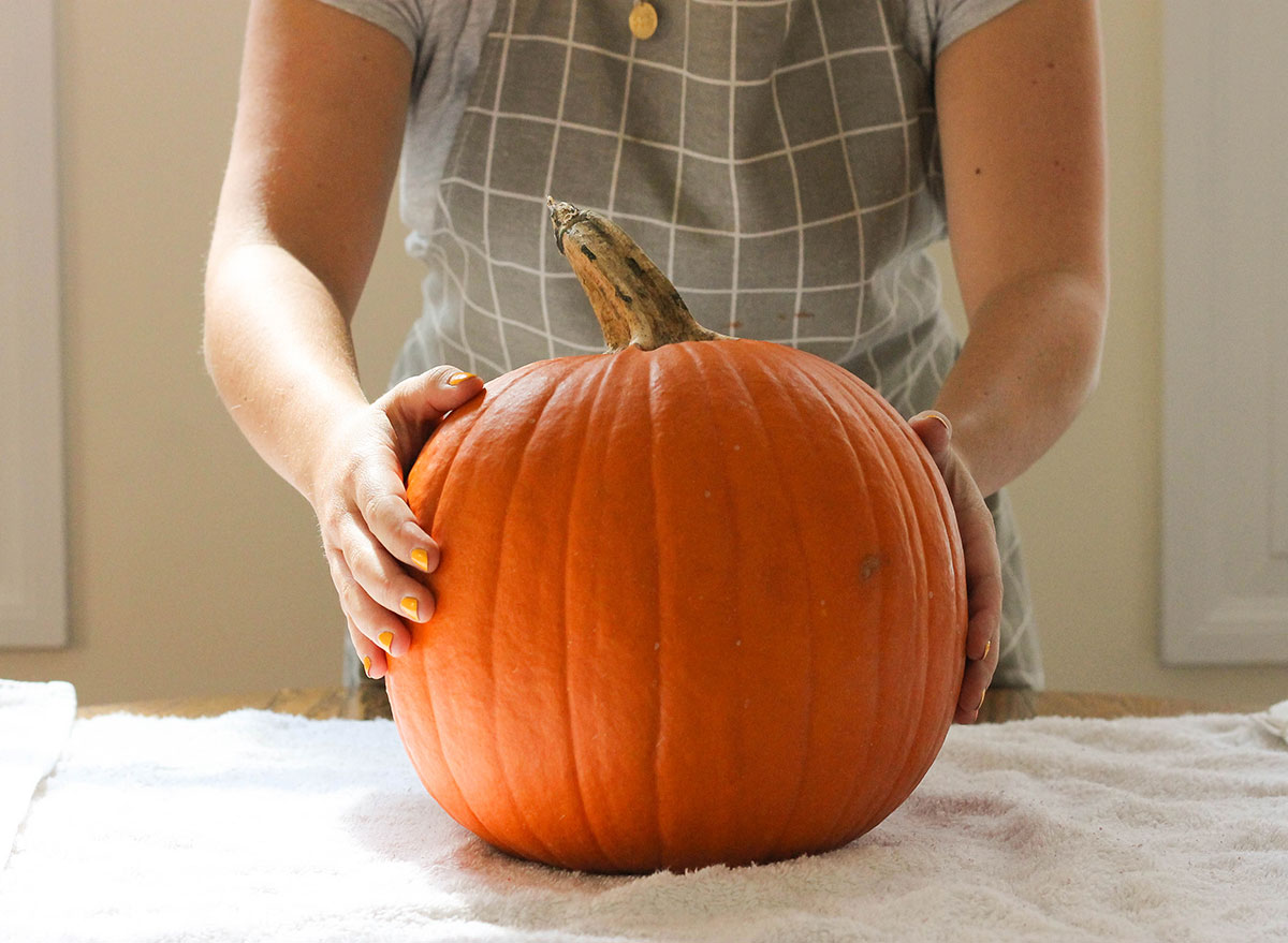 Medium size pumpkin on a table with a towel