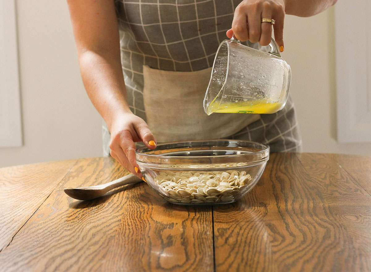 Pouring butter into pumpkin seeds