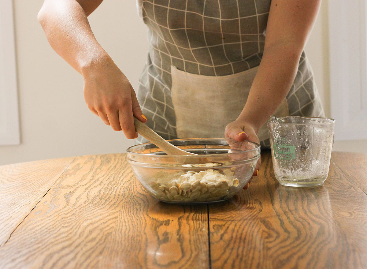 Mixing pumpkin seeds with butter