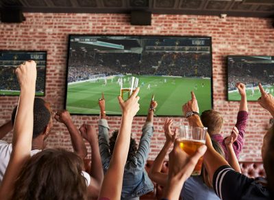 people watching a game at a sports bar