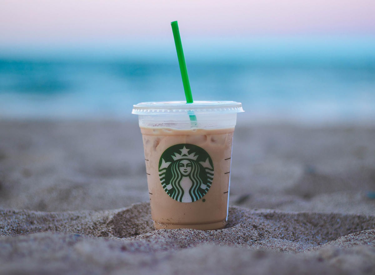 Starbucks iced coffee cup on a beach