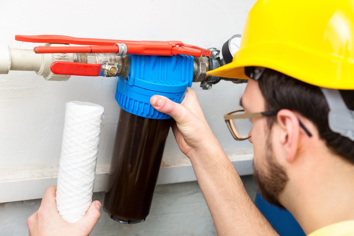 plumber changing dirty water filter