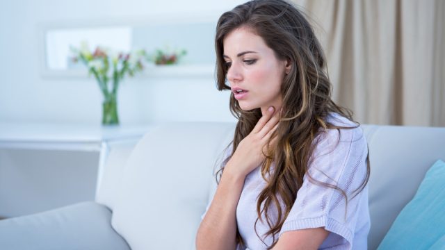 woman doing asthma crisis at home in the living room