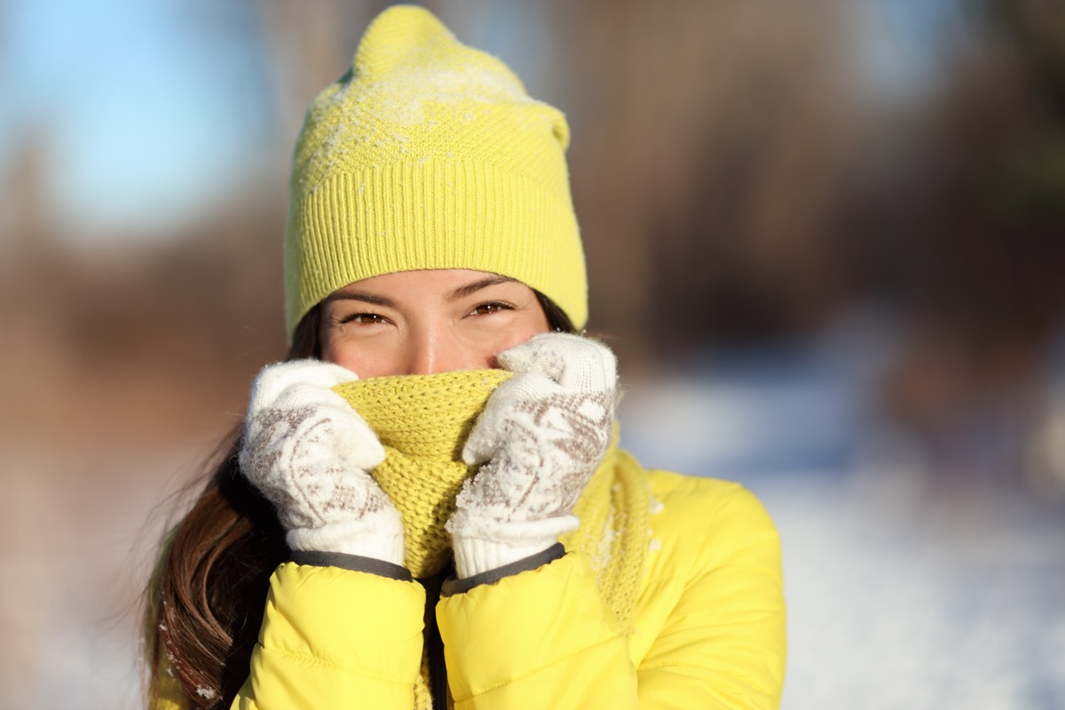 woman covering face from cold