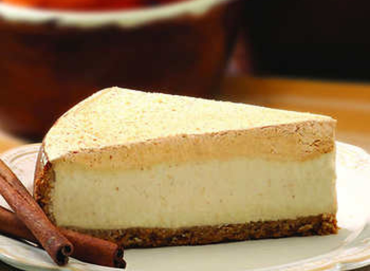 slice of cheesecake with cinnamon stick next to it