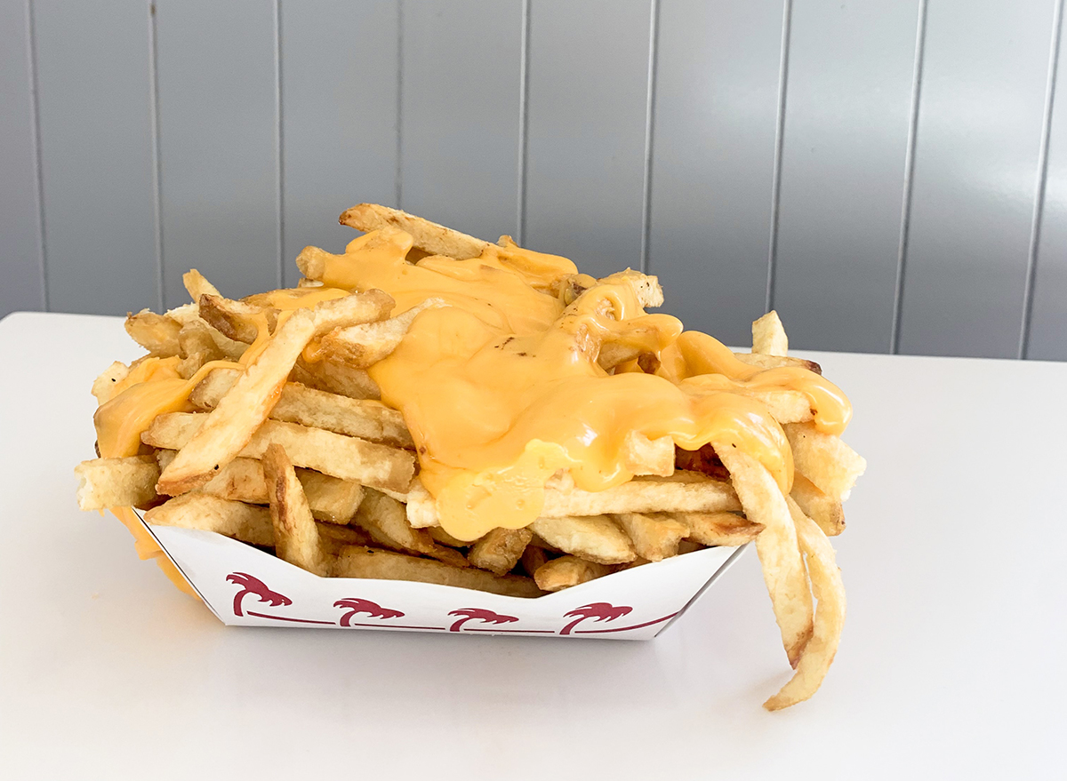 Cheesy fries at In-n-Out with fries piled and cheese spread on top