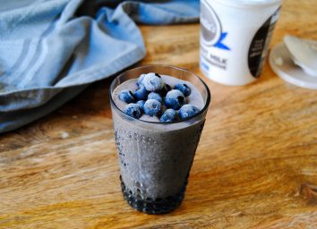 paleo blueberry meal replacement shake with blueberries on top in glass