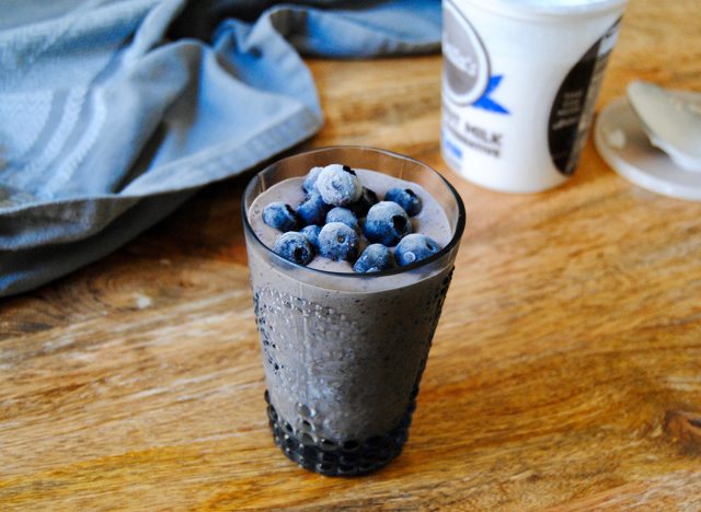 paleo blueberry meal replacement shake with blueberries on top in glass