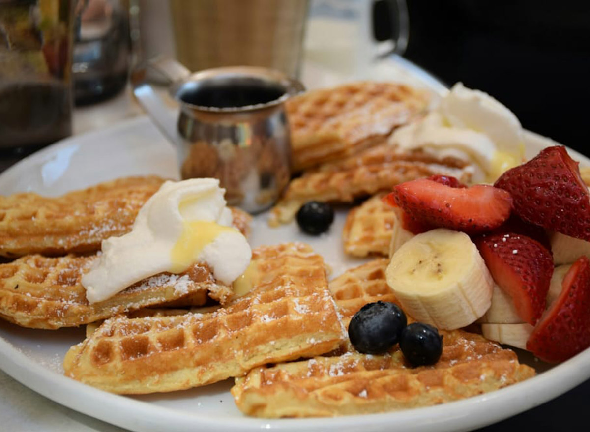 waffles with fruit and whipped cream with syrup on the side from cafe la maude