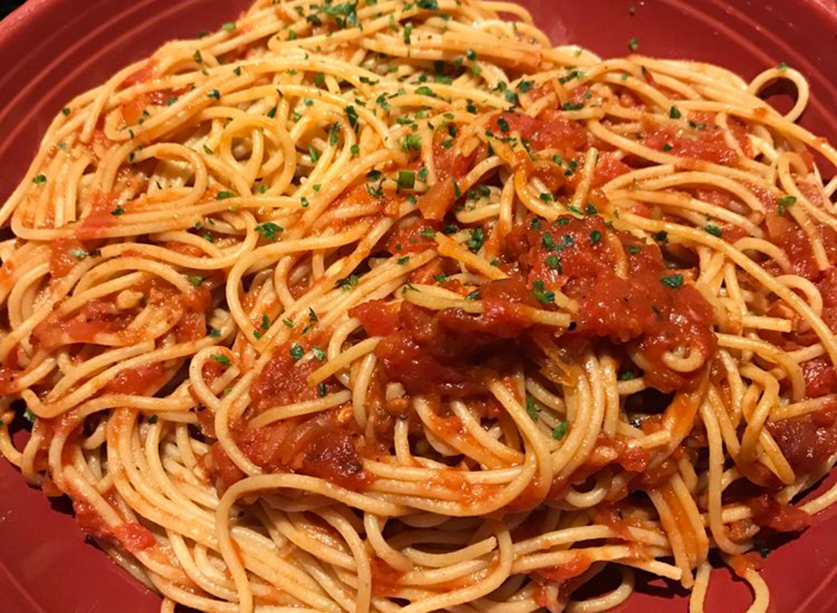 carrabbas whole grain spaghetti with pomodoro sauce on red plate