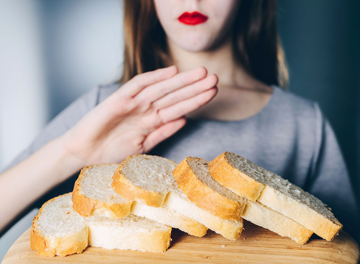 Woman refusing bread because of her celiac disease diet