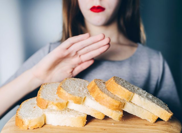 Woman refusing bread because of her celiac disease diet