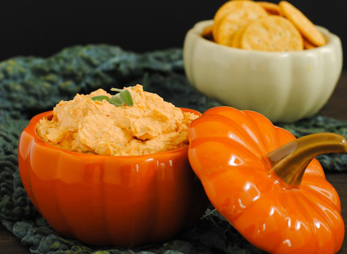 creamy pumpkin parm dip in a ceramic pumpkin