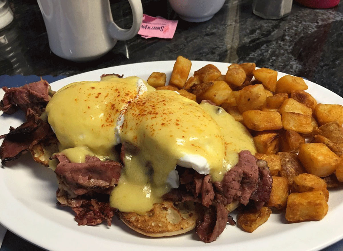 eggs benedict with hash browns on a plate from little depot diner