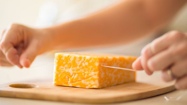 Easily cutting cheese with a piece of floss