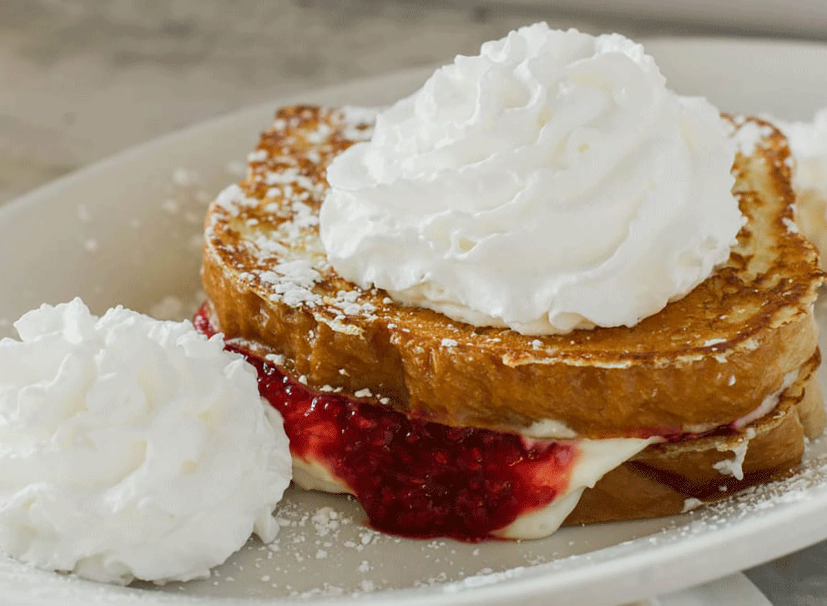 french toast with strawberry jelly and cream in the middle and whipped cream on top from rosies restaurant