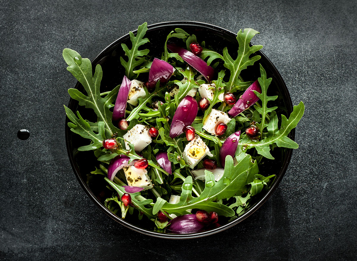 fresh arugula salad with feta, onion, and pomegranate