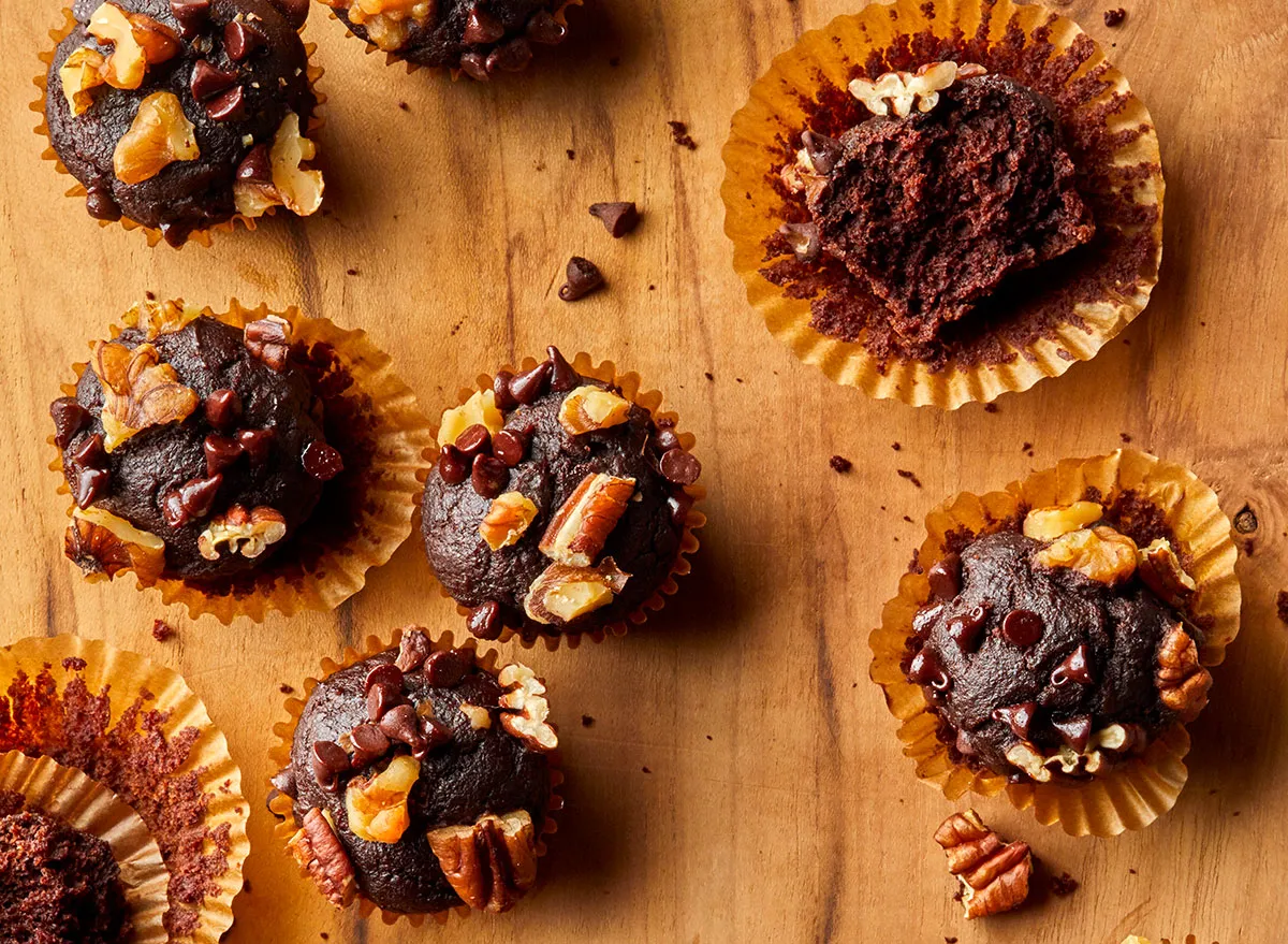 Fudgy pumpkin brownie bites on a wooden cutting board