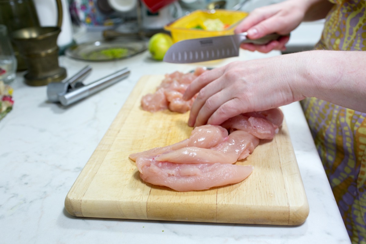 preparing chicken in the kitchen
