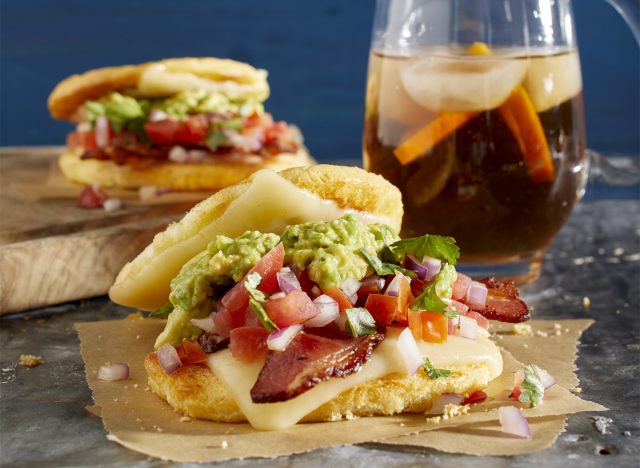 keto bacon cheese sandwich on parchment paper with tea in the background