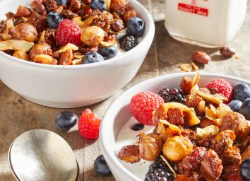 Keto nut and granola recipe in a bowl with fruit and milk