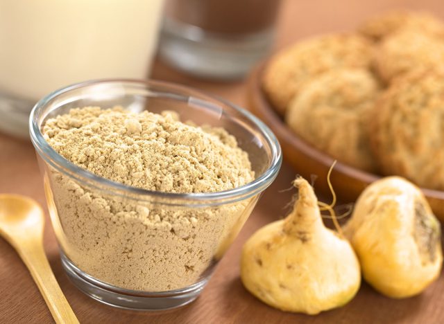 maca root and powder with wooden spoon