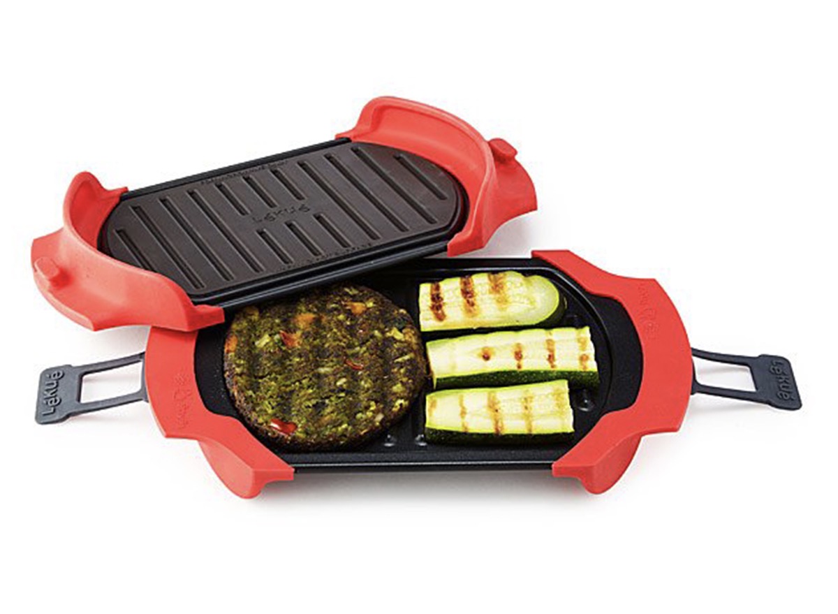 two black and red grill discs with veggie burger and zucchini slices on them