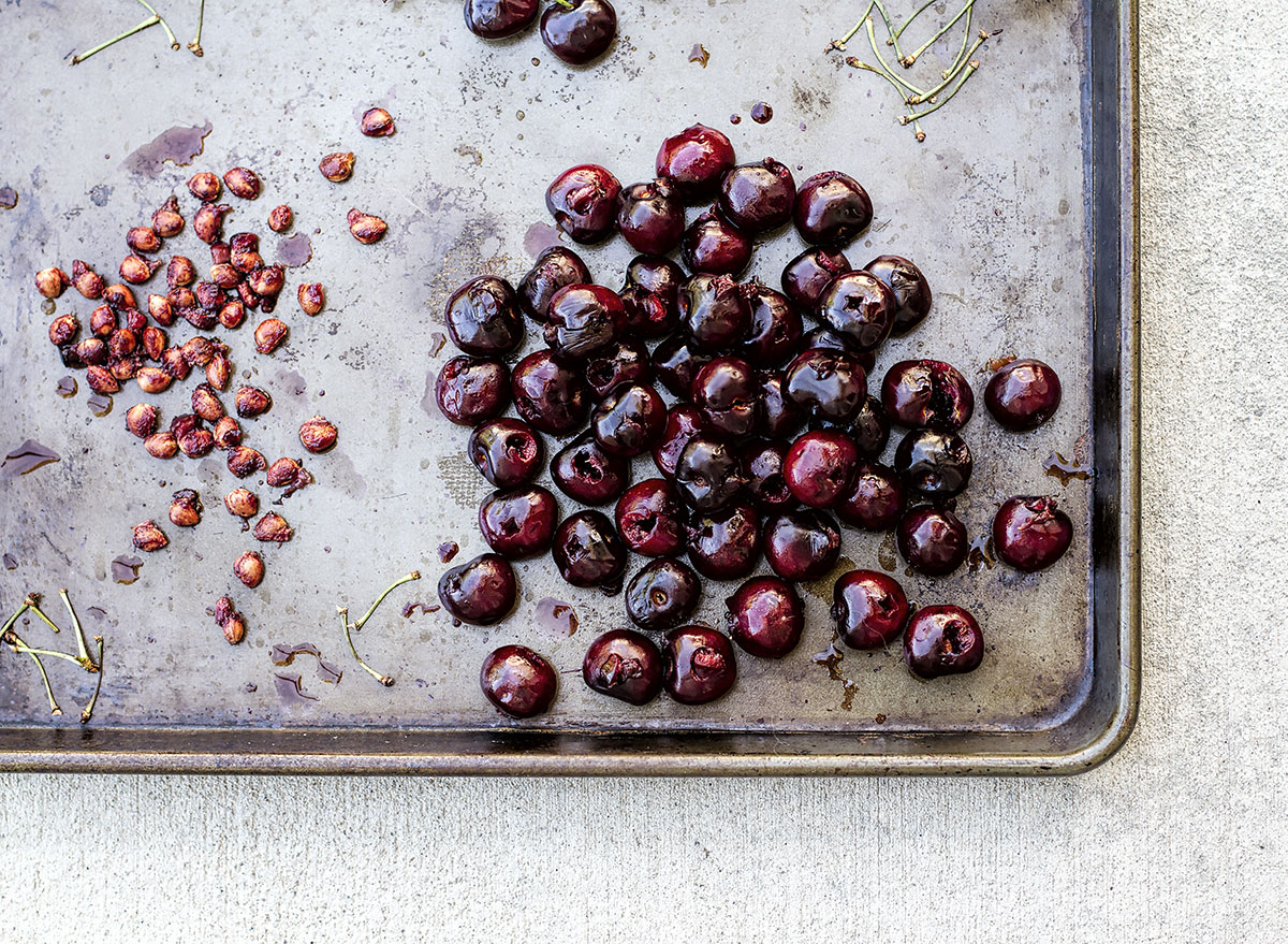 Cherries pitted on a baking sheet