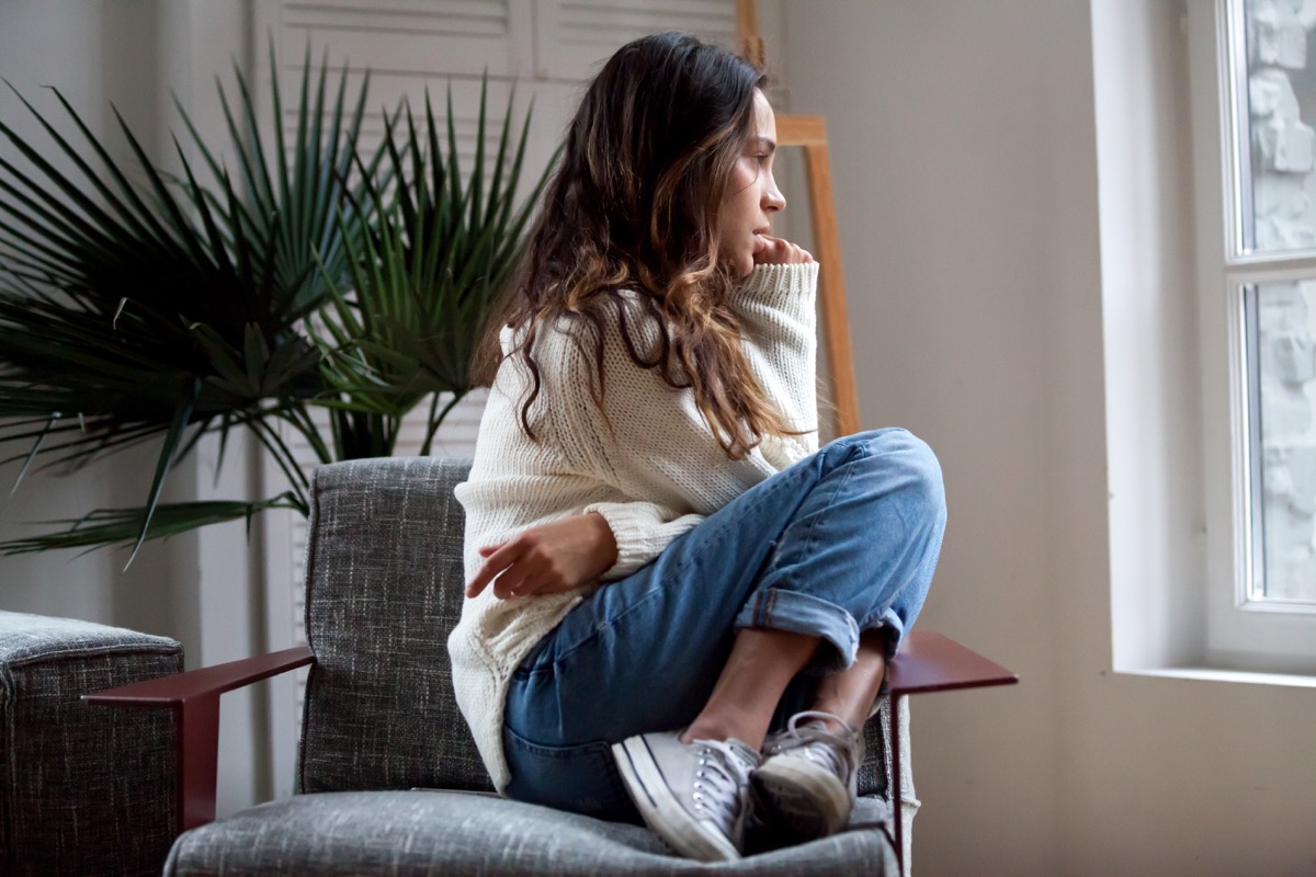 Sad thoughtful teen girl sits on chair feels depressed