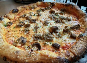 Sausage and mushroom pizza at Wooden City