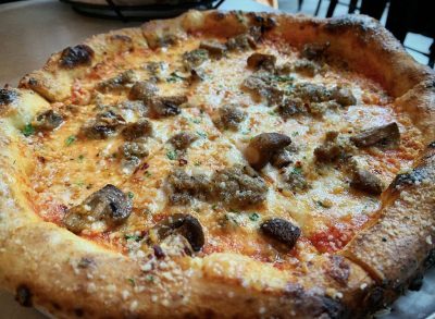 Sausage and mushroom pizza at Wooden City