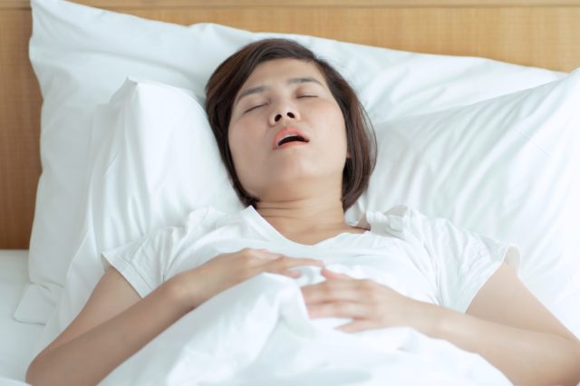 Asian woman sleeps and cannot breathe