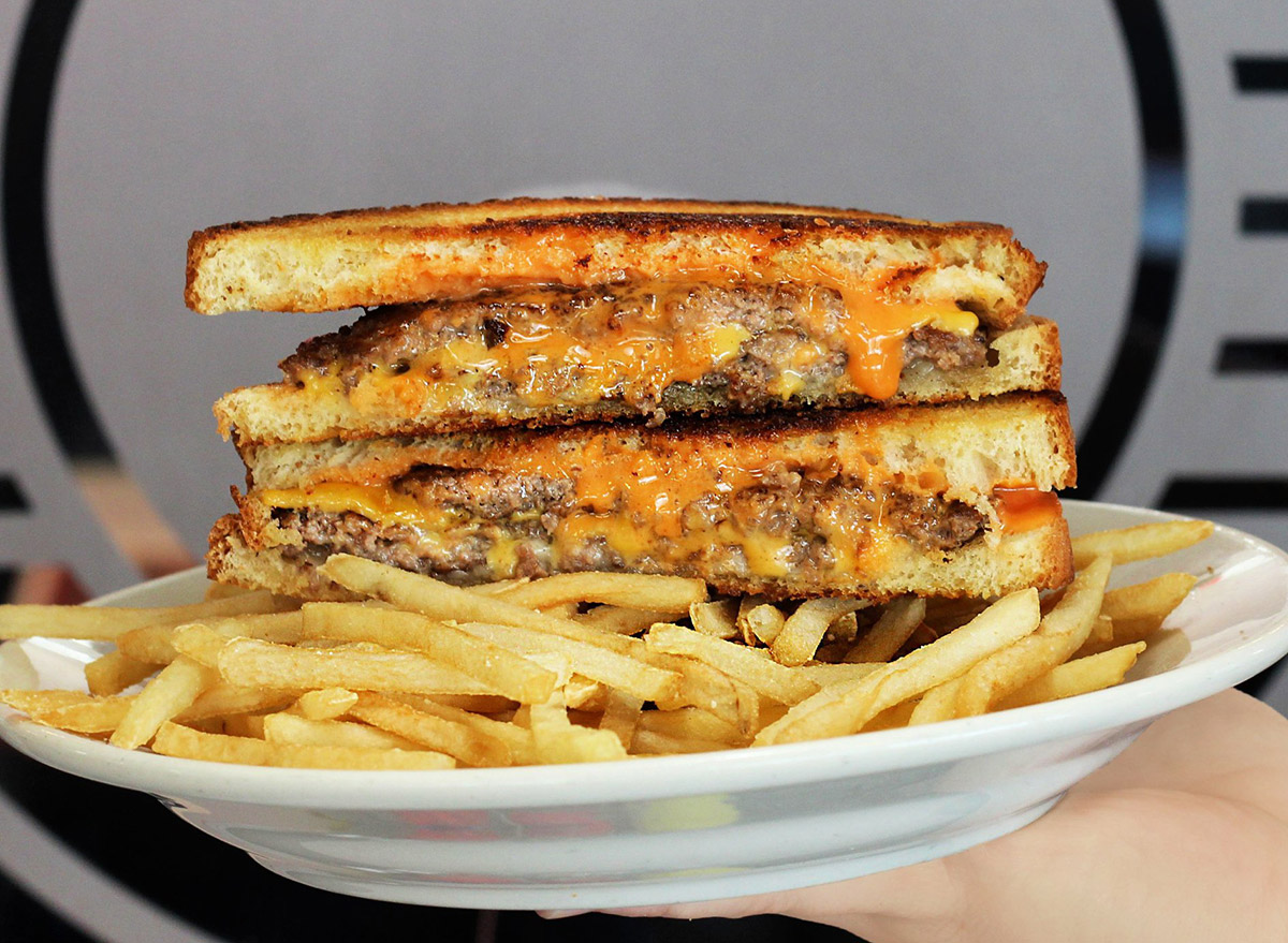 steak n shake frisco melt with a side of french fries on a plate