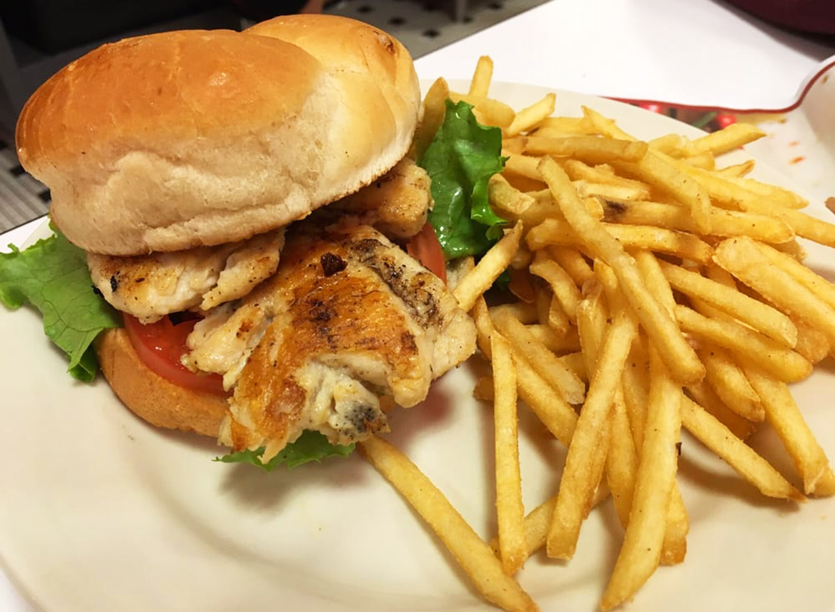 steak n shake grilled chicken sandwich on a plate with fries on the side