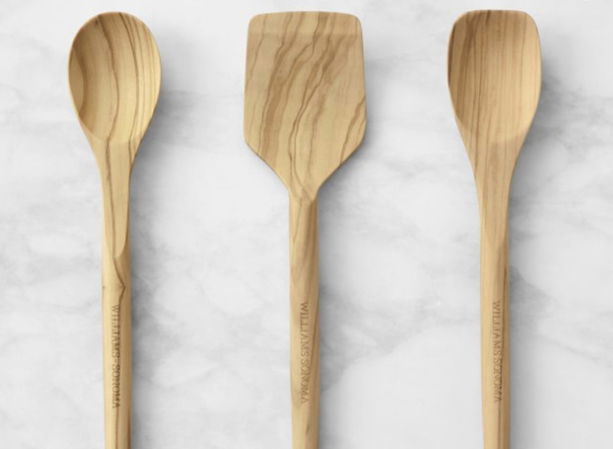 three wooden spoons on marble background