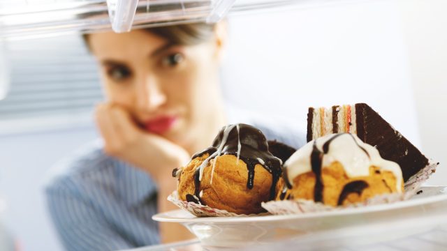 Woman craving junk food while on a diet